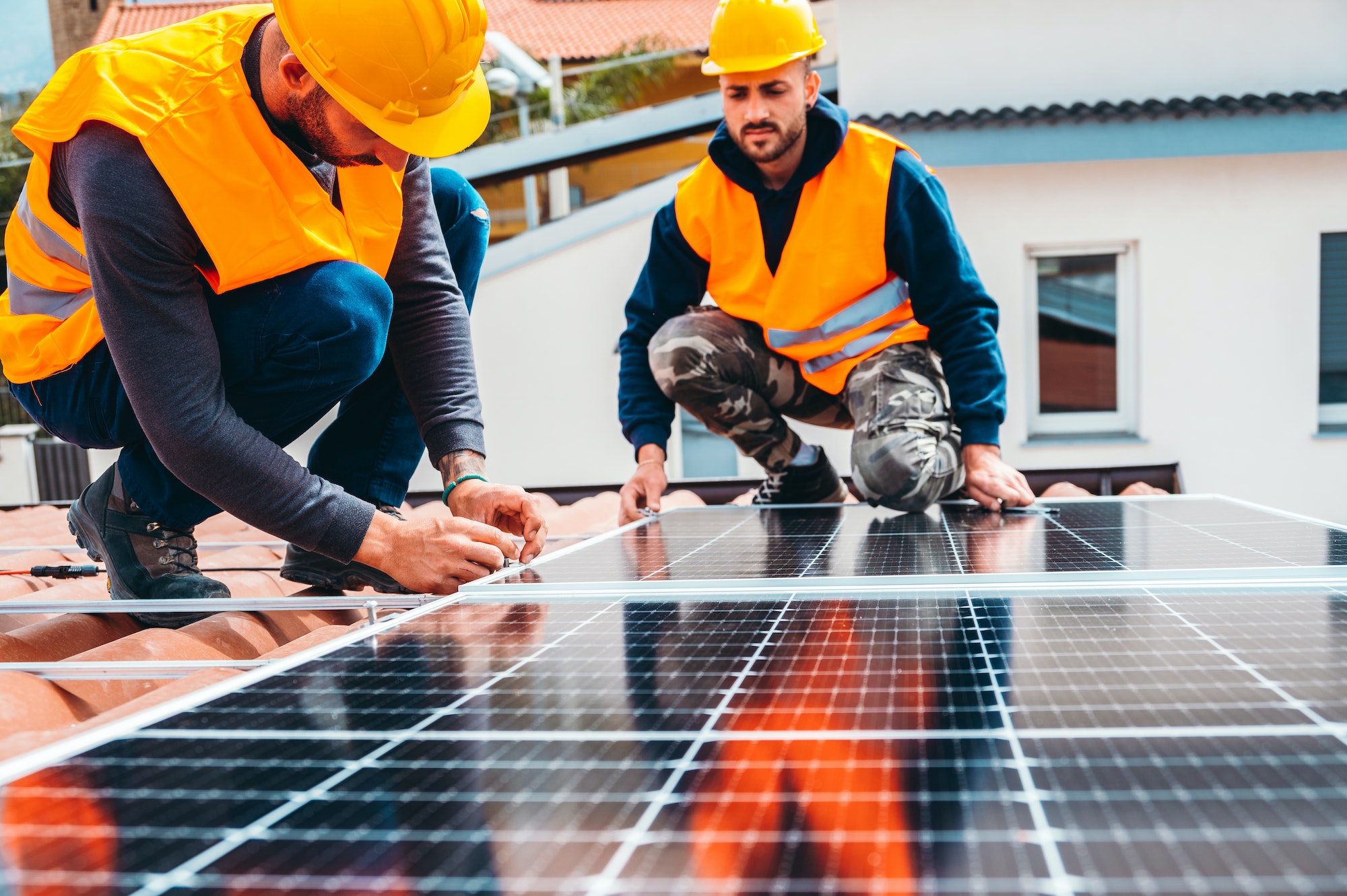 Workers assemble energy system with solar panel for electricity